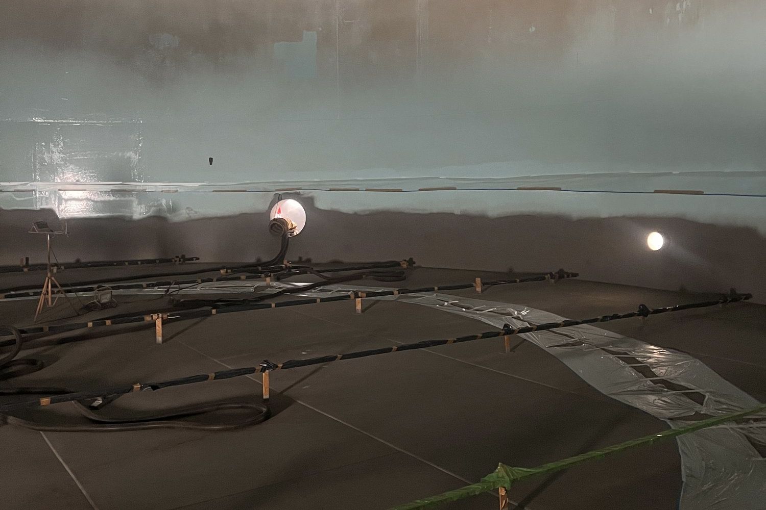 Inside a storage tank during tank lining works: blasted tank floor and protected zones by Russo NV
